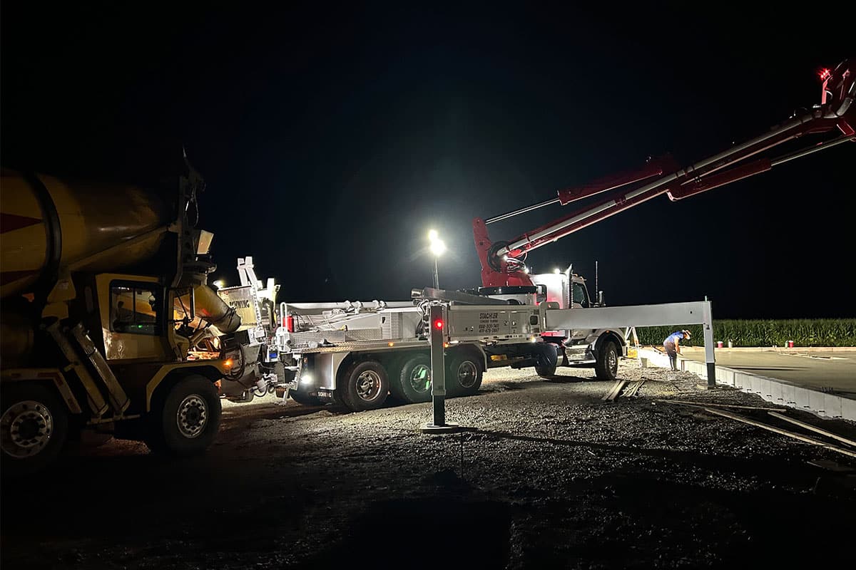 A Spring Creek cement truck at a worksite during the night. 