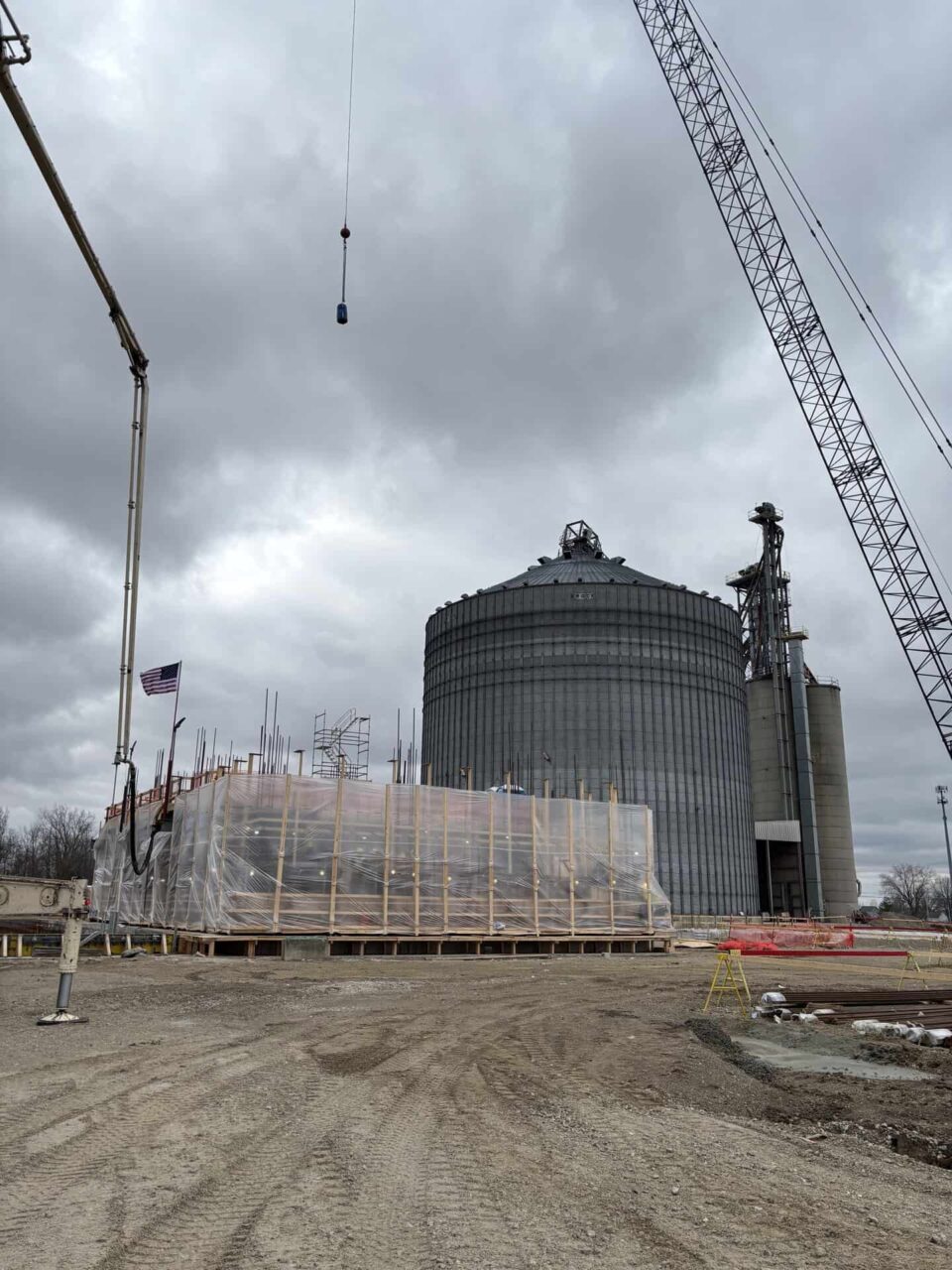 Construction at the Hardin plant with cranes, large tanks, and covered structures for spring creek operations update.