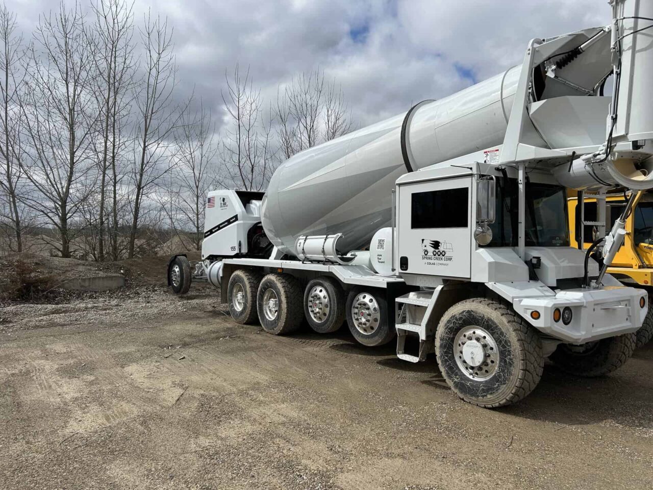 Concrete mixer truck at Spring Creek's new plant, highlighting creek operations update and new equipment.