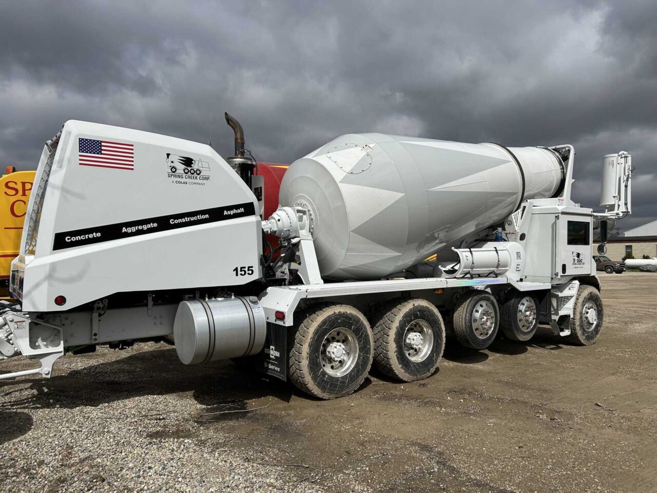 Spring Creek Corp cement mixer truck at new plant project, showcasing upgraded operations equipment.