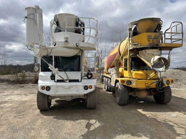 Two concrete mixer trucks at the Spring Creek operations site showcasing new plant projects equipment.